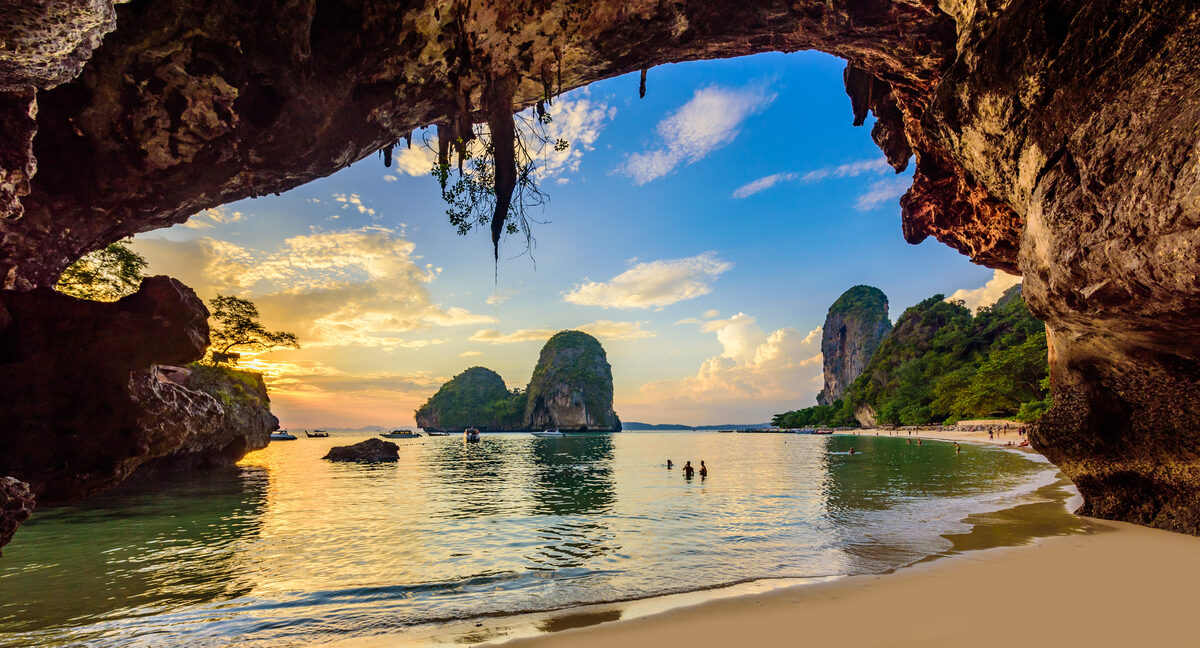 Sunset over a tropical beach with limestone cliffs