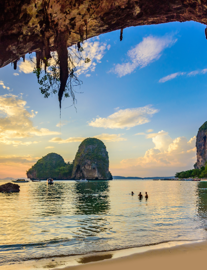 Limestone cliffs over a Thai bay at dusk