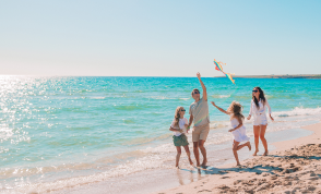A family running on a beach